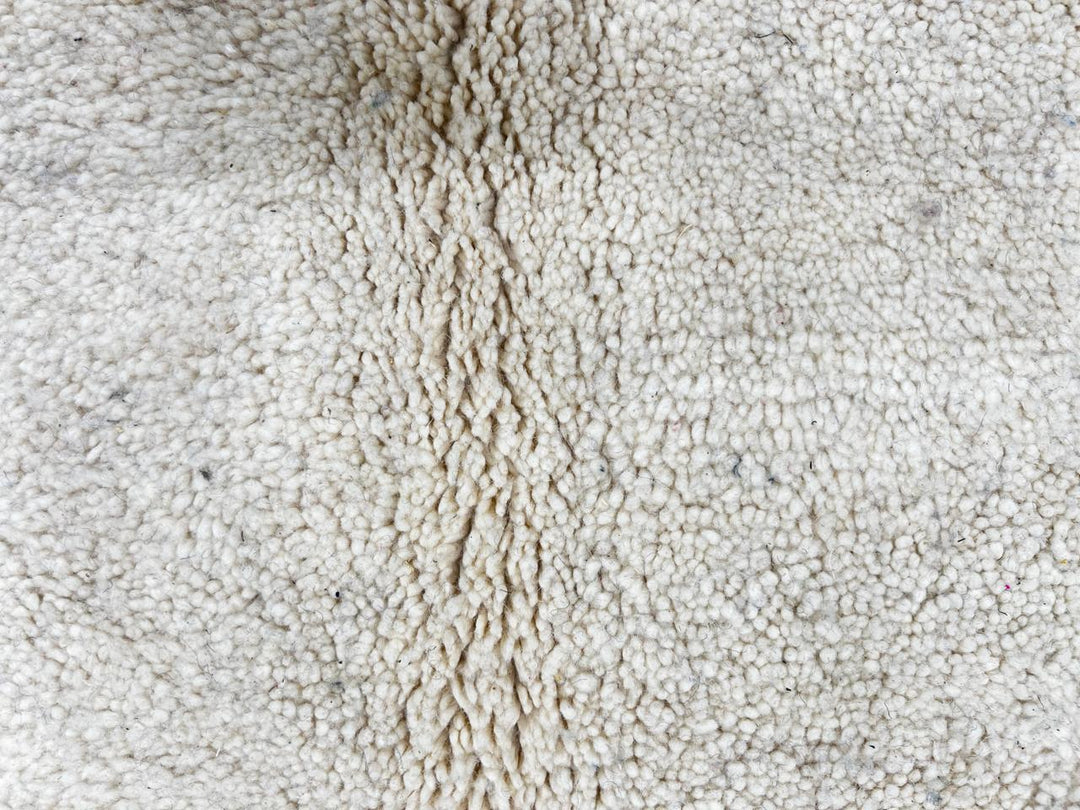 Handmade ivory Moroccan wool rug with green, blue, and black geometric abstract patterns