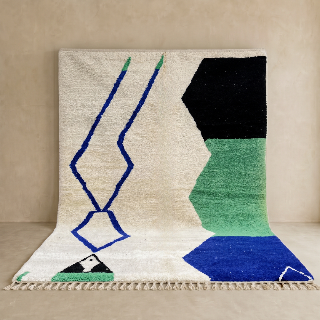 Handmade ivory Moroccan wool rug with green, blue, and black geometric abstract patterns