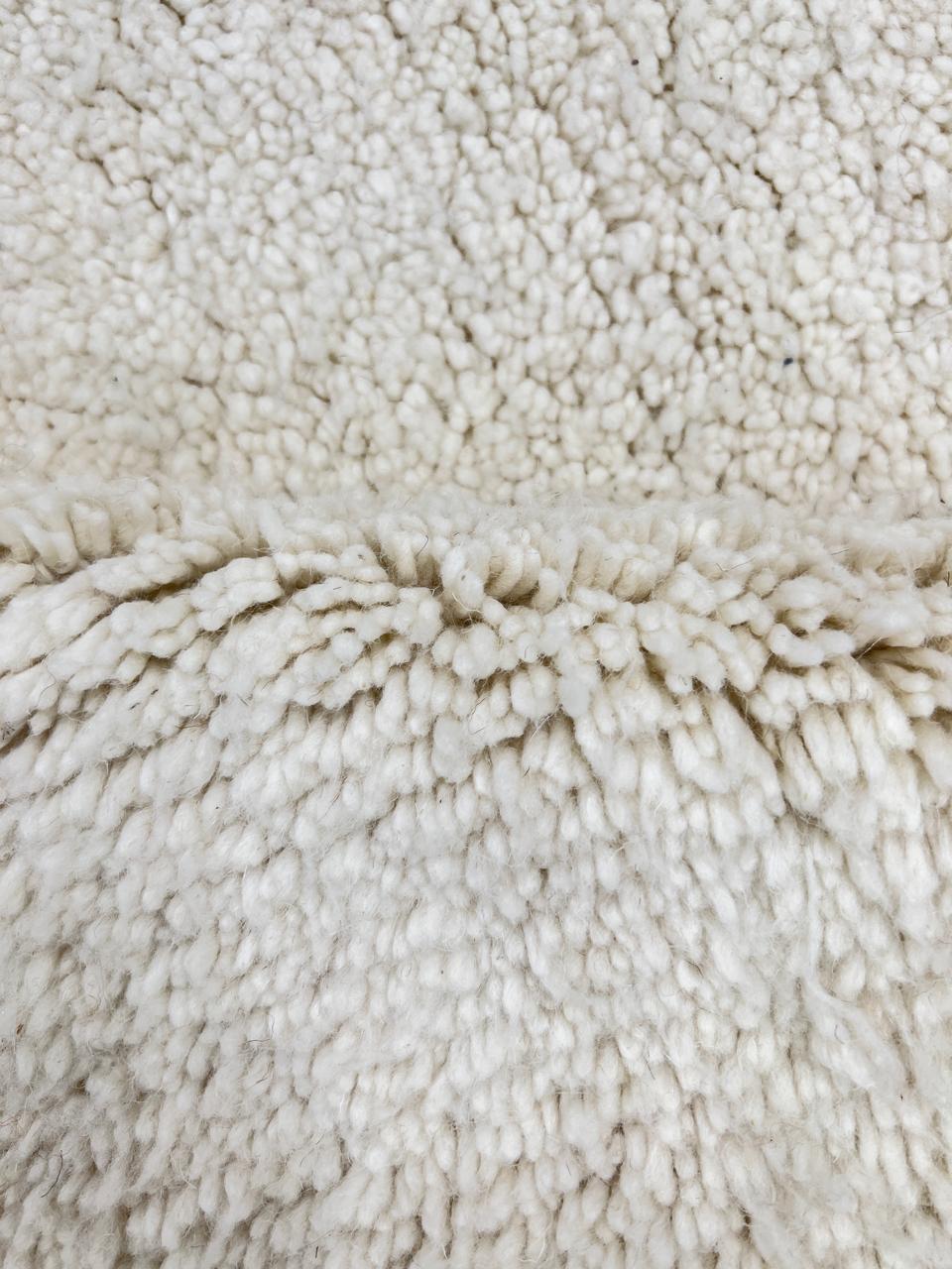 Ivory handmade Moroccan wool rug with plush soft texture and minimalist design