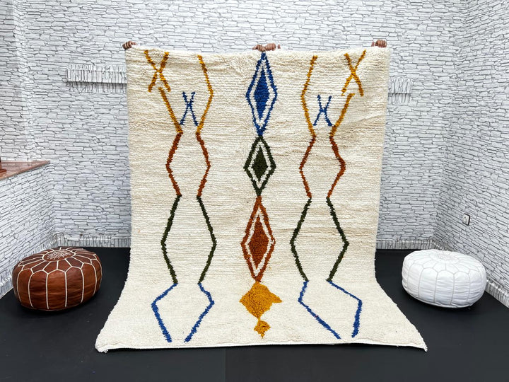 Handwoven ivory Moroccan wool rug with blue, amber, and olive geometric Berber designs