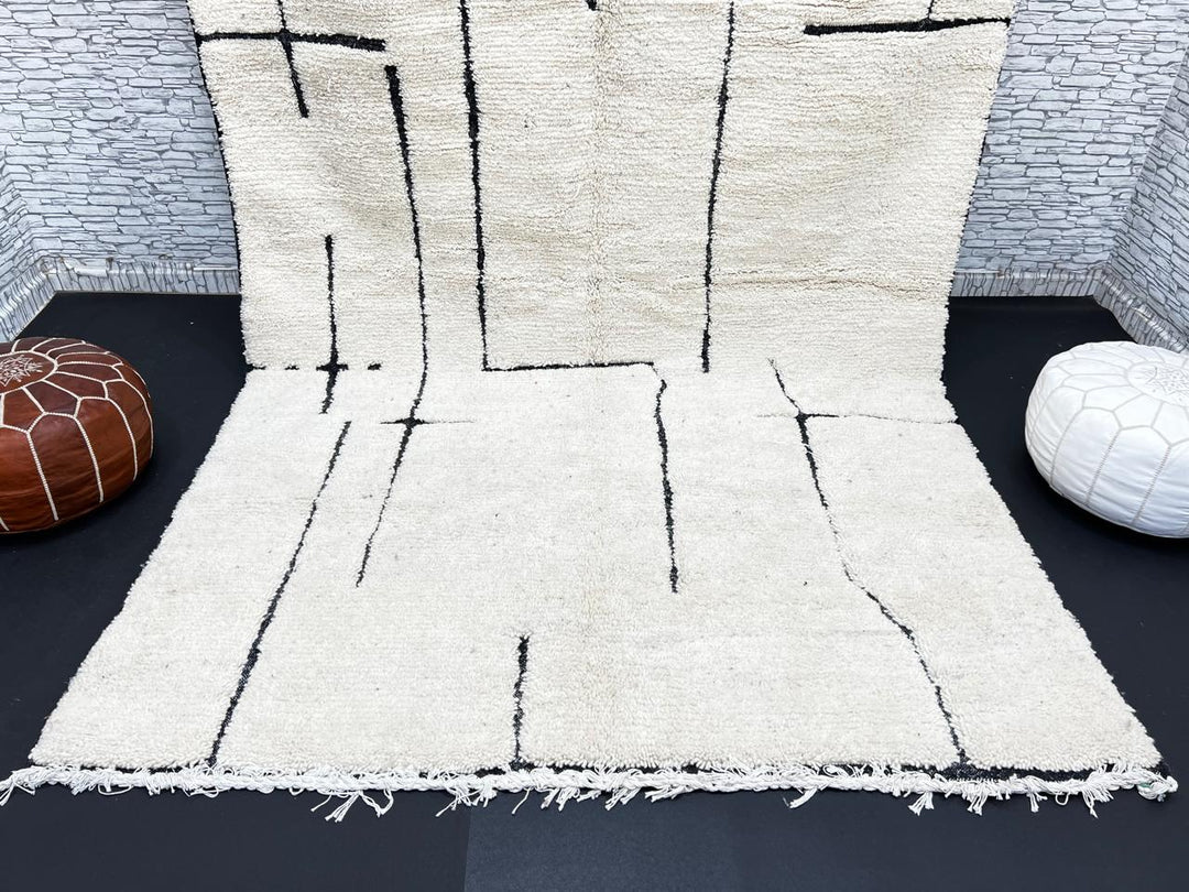Handmade ivory Moroccan wool rug with abstract black line design – modern Beni Ourain style