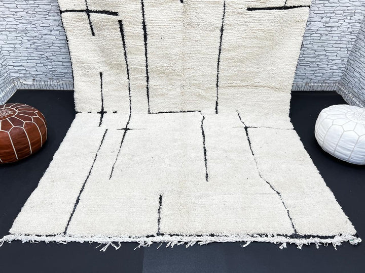 Handmade ivory Moroccan wool rug with abstract black line design – modern Beni Ourain style