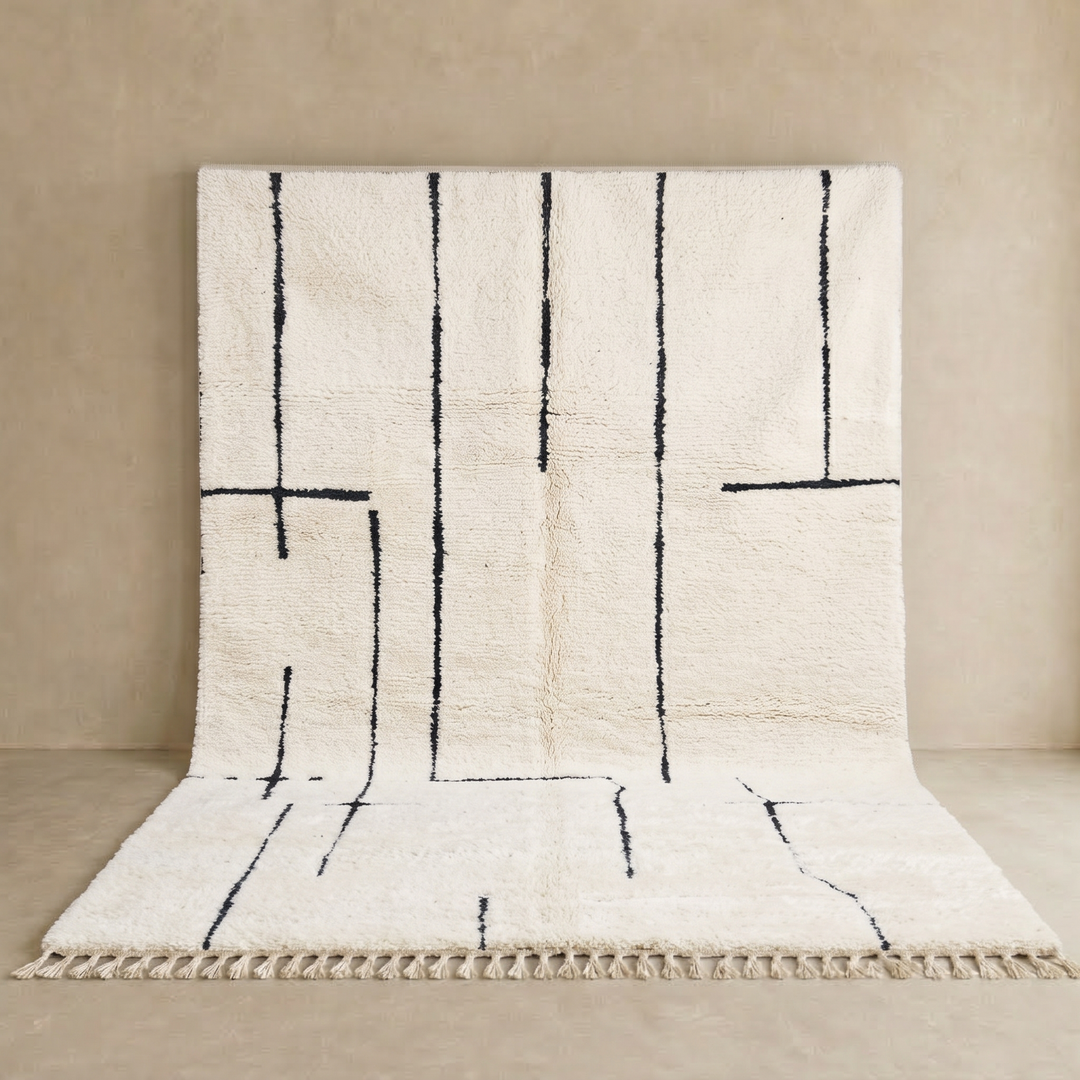 Handmade ivory Moroccan wool rug with abstract black line design – modern Beni Ourain style