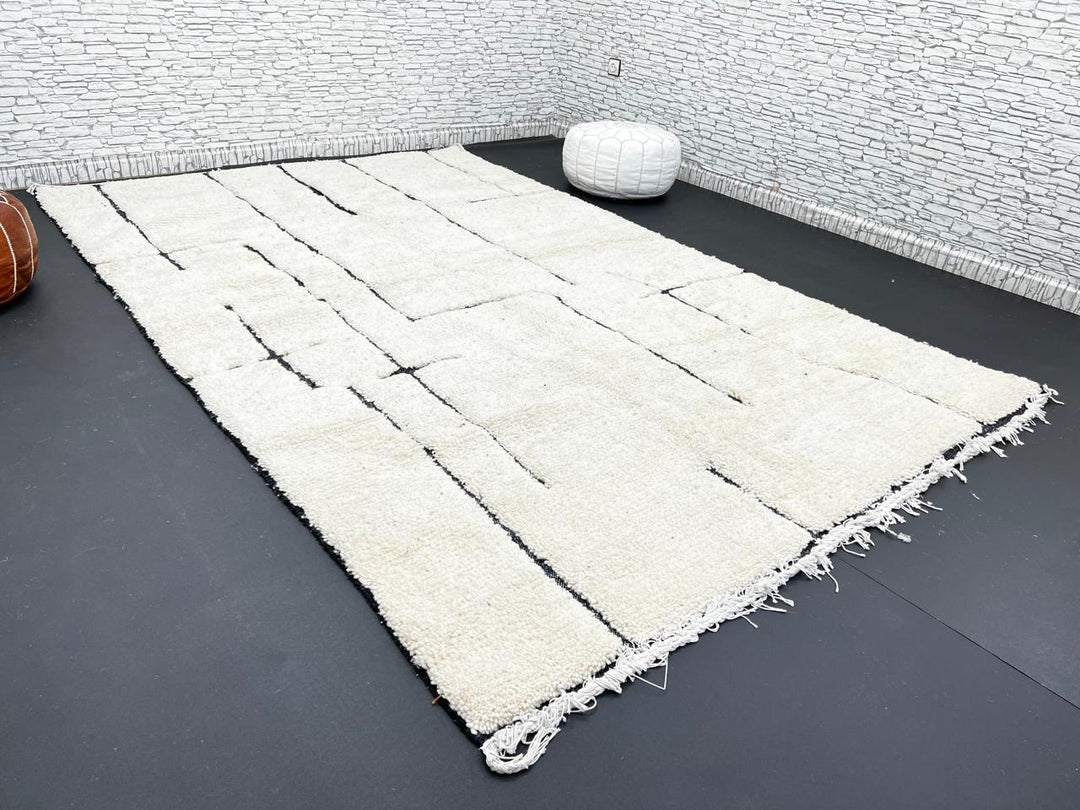 Handmade ivory Moroccan wool rug with abstract black line design – modern Beni Ourain style
