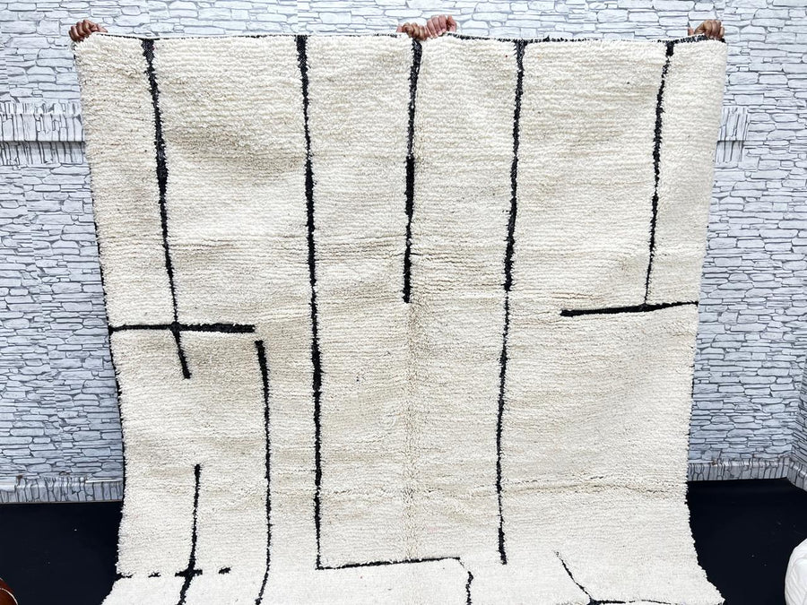 Handmade ivory Moroccan wool rug with abstract black line design – modern Beni Ourain style