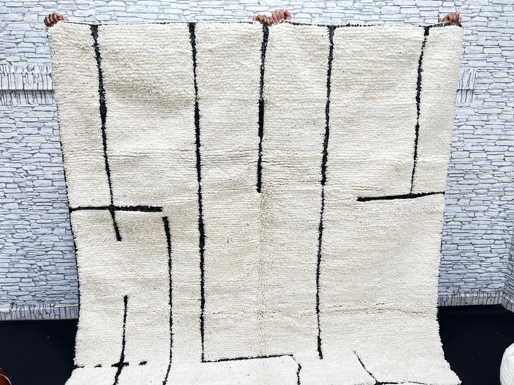 Handmade ivory Moroccan wool rug with abstract black line design – modern Beni Ourain style