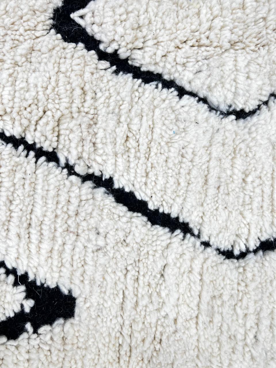 Ivory Moroccan wool rug with black diamond lattice handmade by Berber artisans