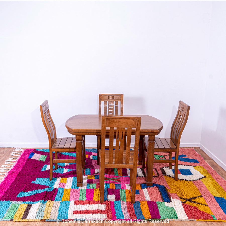 Handmade Moroccan rug with colorful striped and tribal motifs in vibrant wool