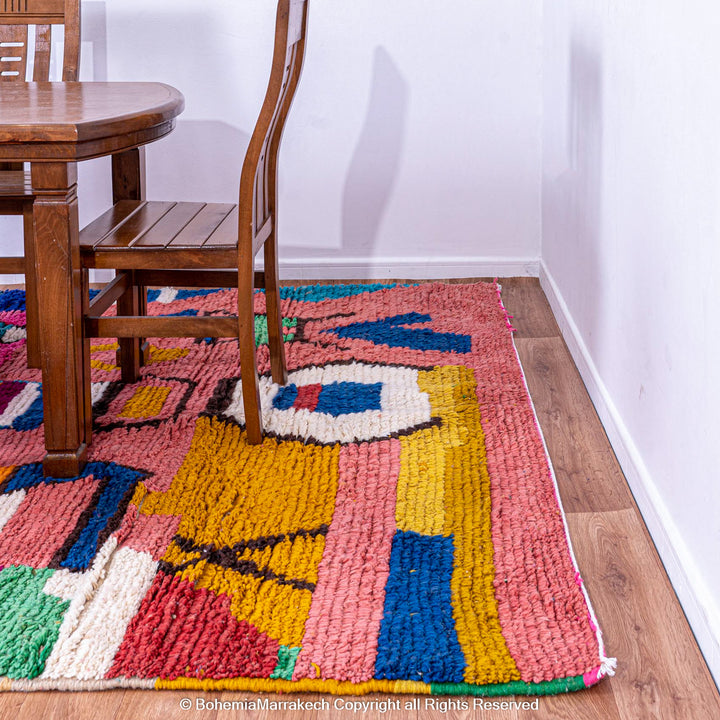 Handmade Moroccan rug with colorful striped and tribal motifs in vibrant wool