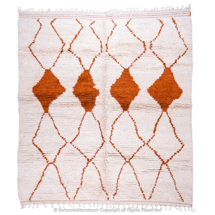 Handmade white Moroccan rug with rust diamond design, crafted from natural wool, featuring traditional Beni Ourain lattice pattern.