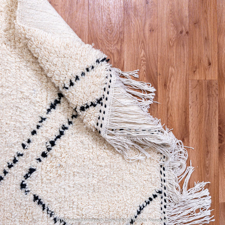 Minimalist Moroccan Beni Ourain rug in black and white wool with hand-knotted tribal motifs