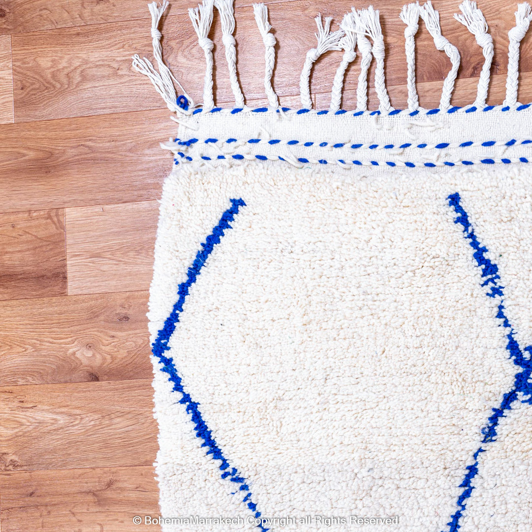 Large Beni Ourain Moroccan wool rug with blue diamond pattern on white background – handmade by Berber artisans