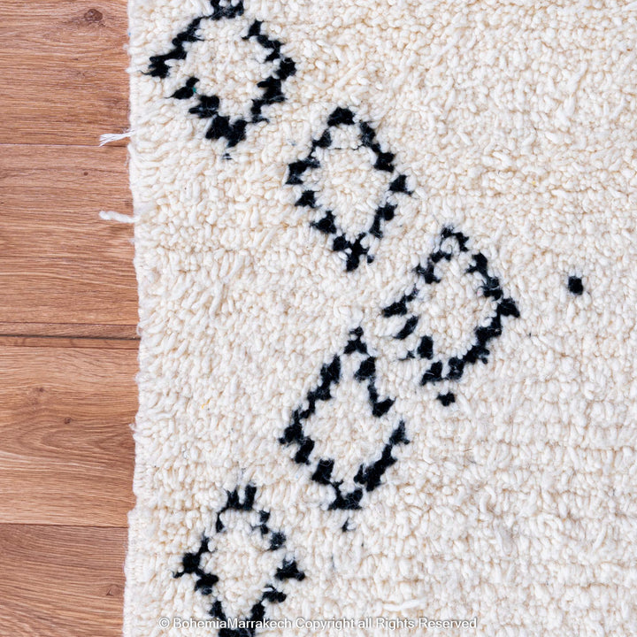 Minimalist Moroccan Beni Ourain rug in black and white wool with hand-knotted tribal motifs