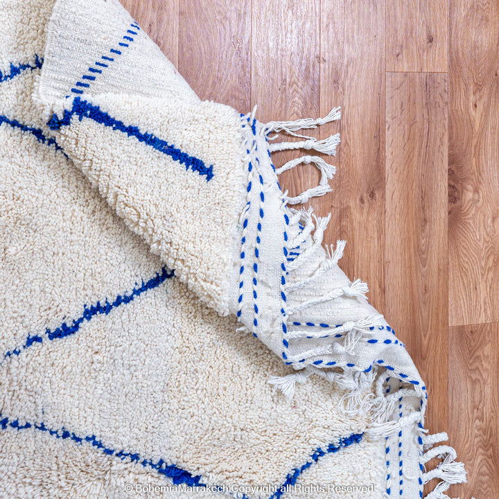 Large Beni Ourain Moroccan wool rug with blue diamond pattern on white background – handmade by Berber artisans