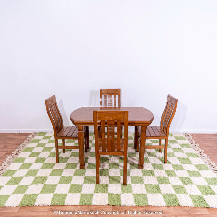 Green white checkered Moroccan rug under dining set, handmade wool rug from Morocco, elevating decor with vintage charm and modern style.