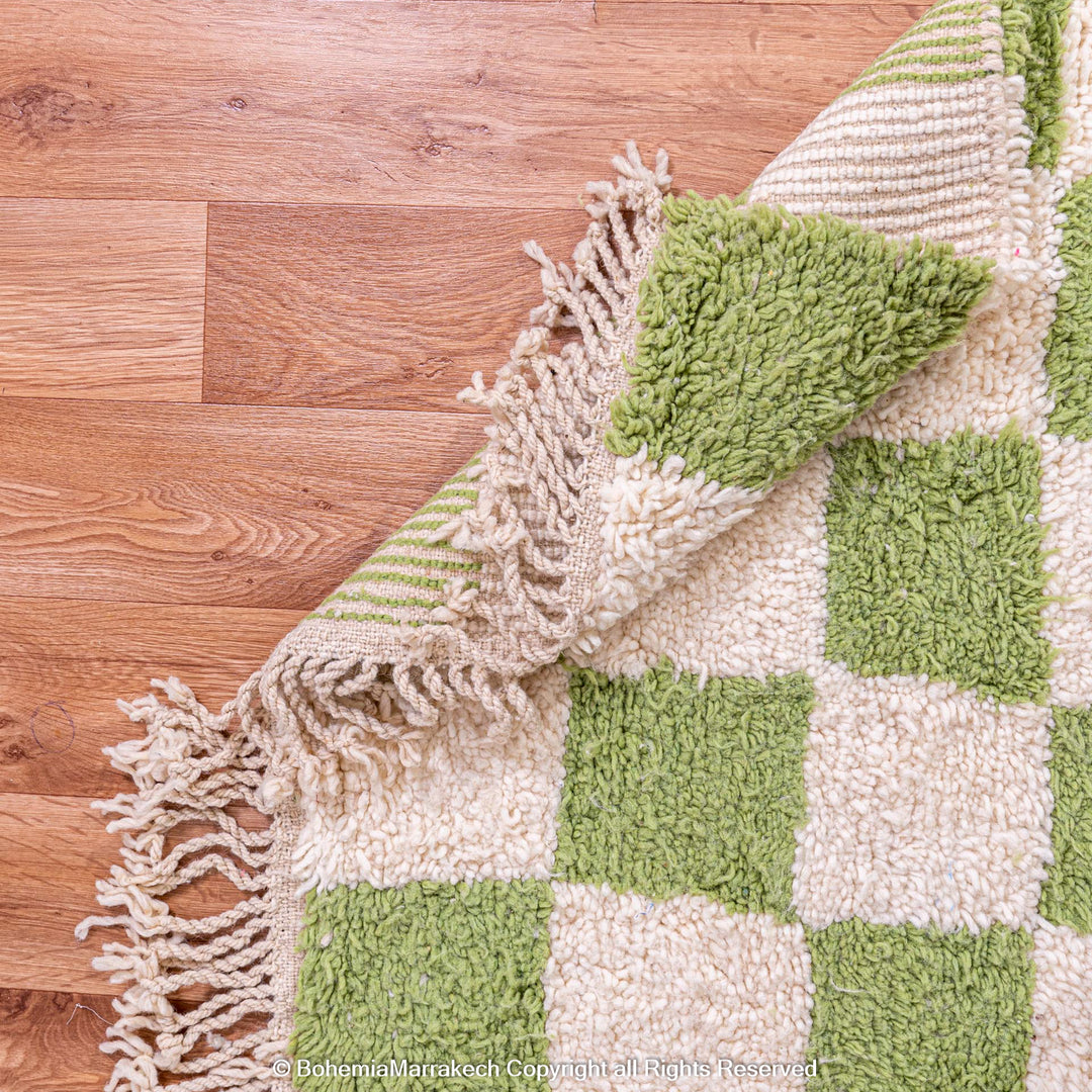 Green and white checkered Moroccan wool rug, handwoven with fringe edges, showcasing a modern yet traditional Berber design.
