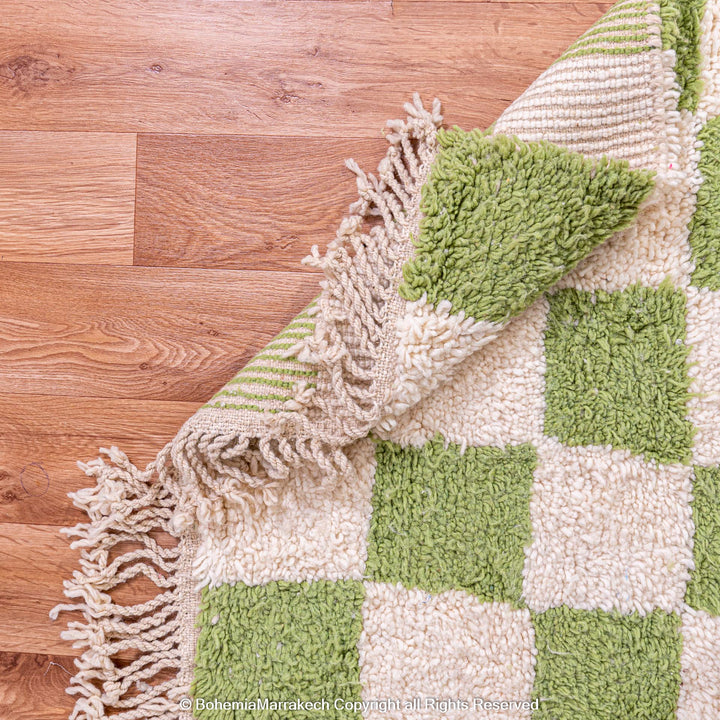 Green and white checkered Moroccan wool rug, handwoven with fringe edges, showcasing a modern yet traditional Berber design.