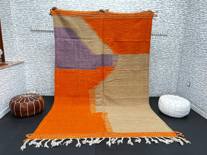 Handwoven Moroccan wool rug in light brown, orange, and purple with geometric modern pattern – natural flatweave Berber carpet