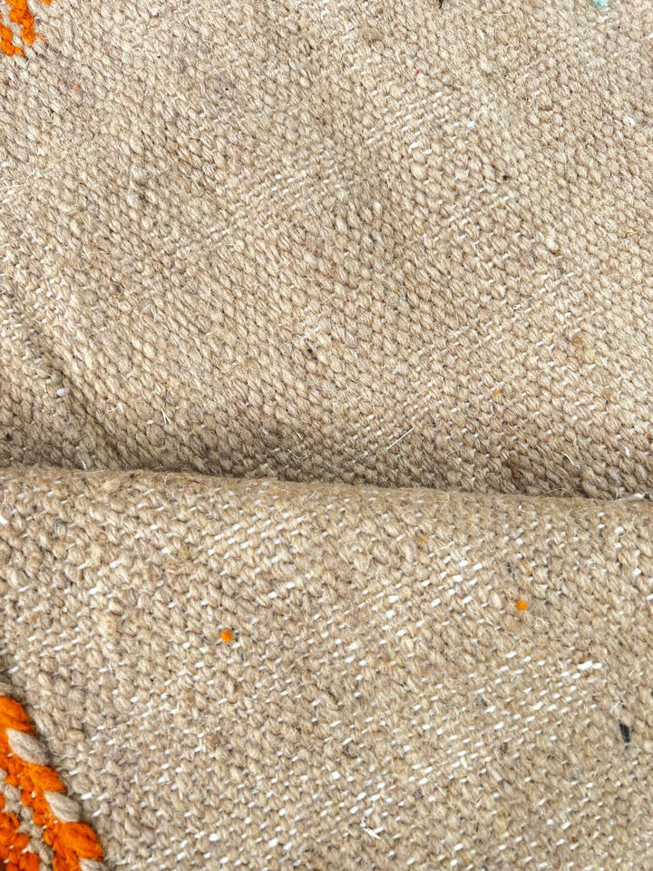 Handwoven Moroccan wool rug in light brown, orange, and purple with geometric modern pattern – natural flatweave Berber carpet