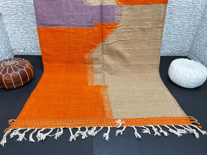 Handwoven Moroccan wool rug in light brown, orange, and purple with geometric modern pattern – natural flatweave Berber carpet