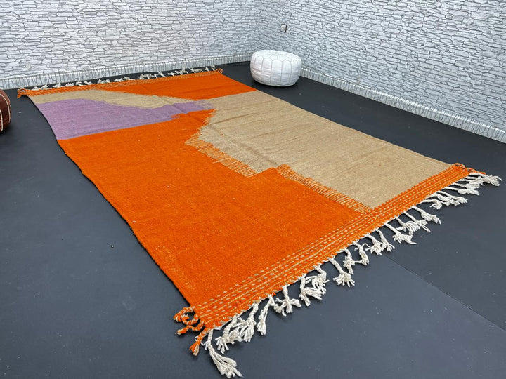 Handwoven Moroccan wool rug in light brown, orange, and purple with geometric modern pattern – natural flatweave Berber carpet