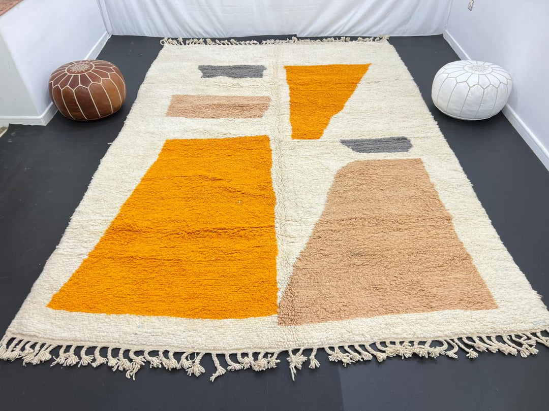 Luxury modern Moroccan wool rug with abstract ochre beige and charcoal color blocks on a cream white background