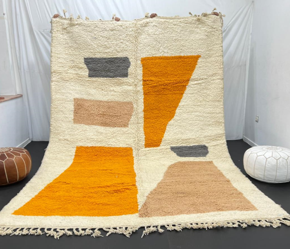 Luxury modern Moroccan wool rug with abstract ochre beige and charcoal color blocks on a cream white background