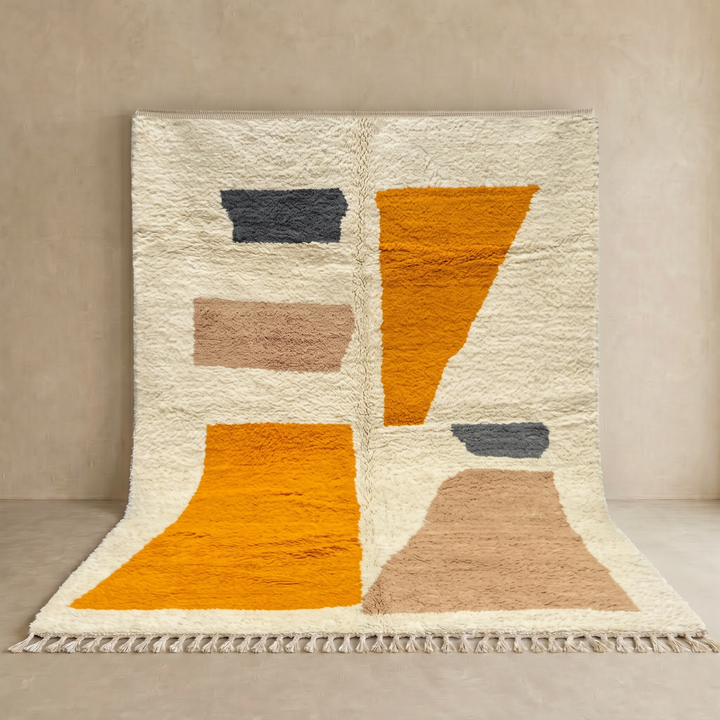 Luxury modern Moroccan wool rug with abstract ochre beige and charcoal color blocks on a cream white background
