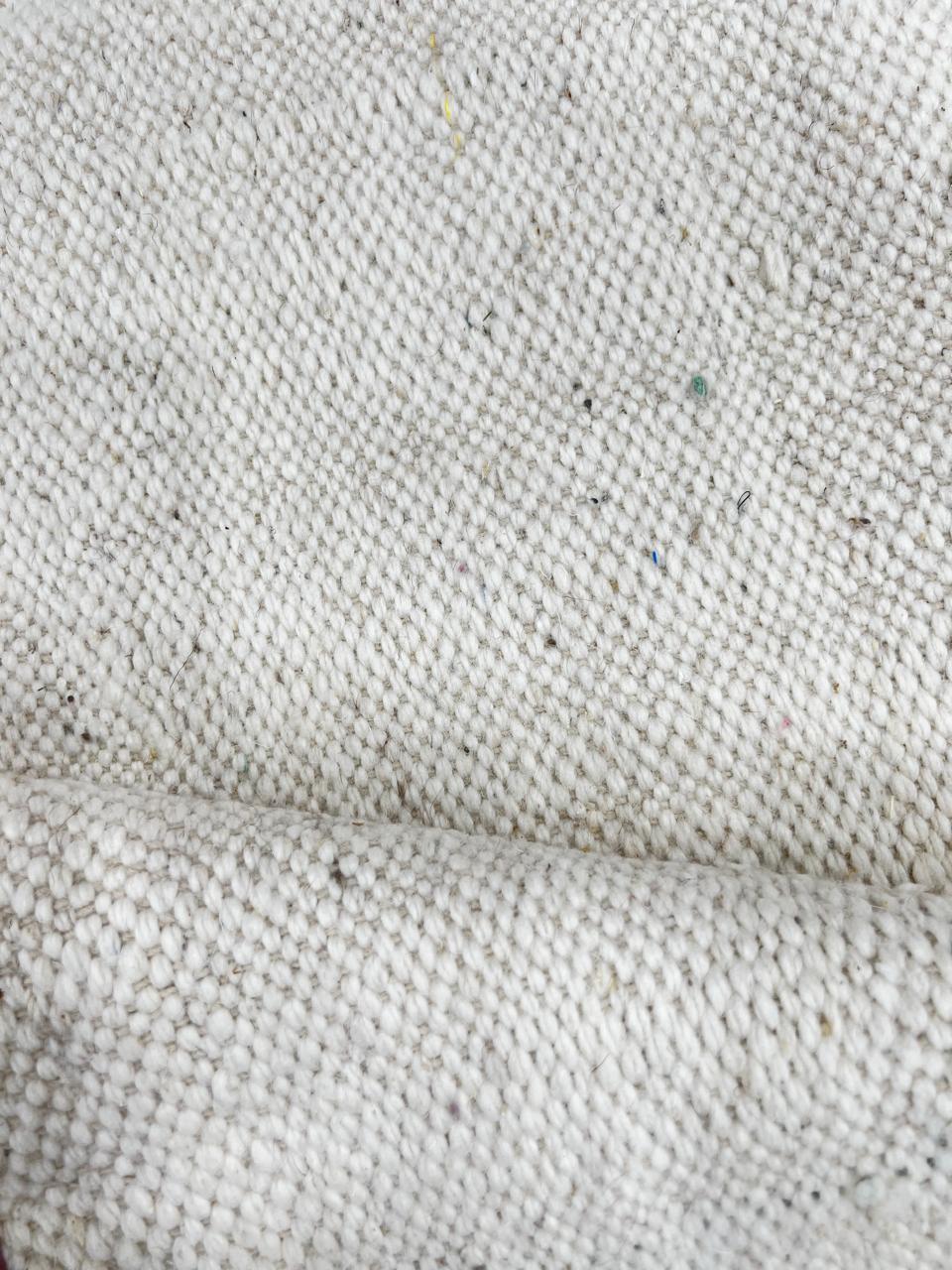 Flat weave round Moroccan wool rug with minimalist abstract pink and purple design on white background