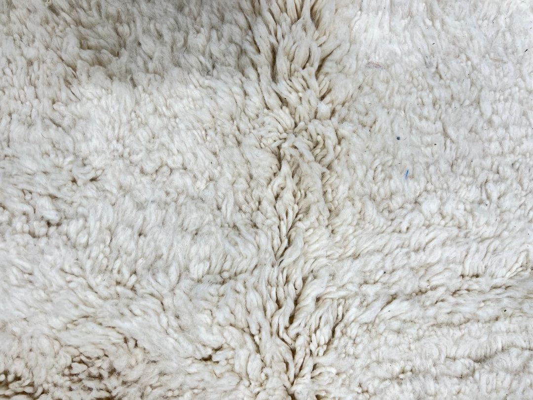 Handmade Moroccan runner rug with white wool center, blue borders, and beige accents, crafted by Berber artisans.