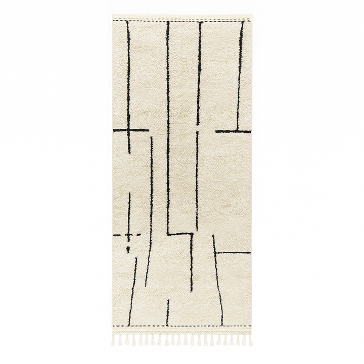 Handmade minimalist Moroccan runner rug with black linear abstract design on natural white wool background.
