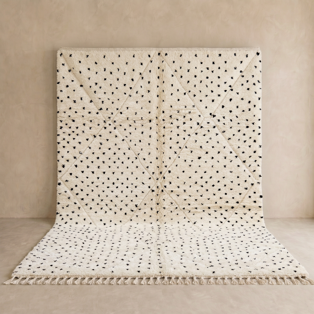 Handwoven Moroccan wool rug with small black dotted patterns on an ivory background, minimalist Beni Ourain design