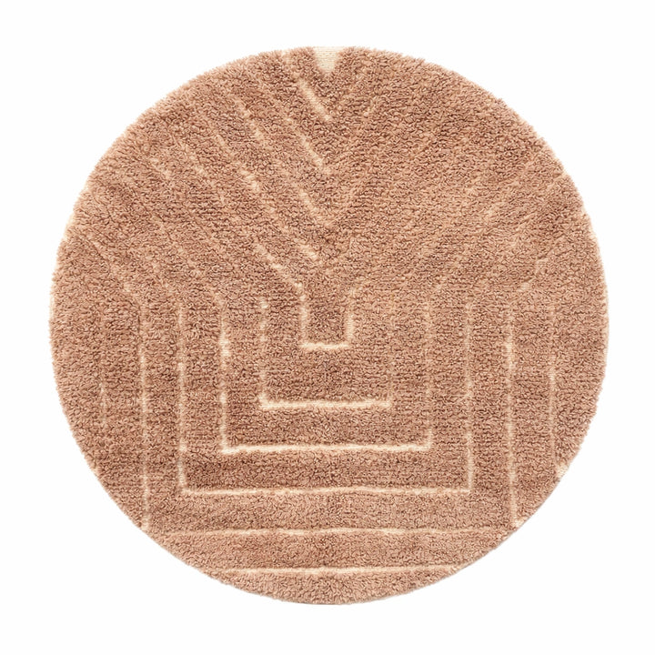 Authentic round Moroccan Berber rug handmade from natural wool with traditional tribal motif in warm beige tones