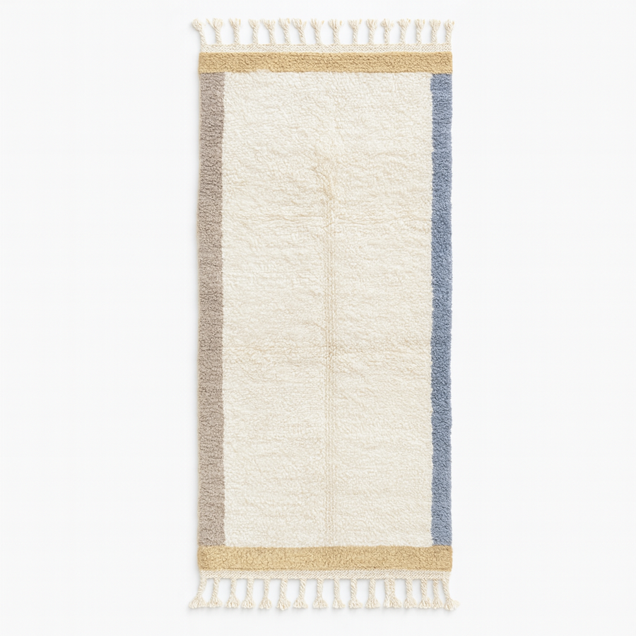 Handmade Moroccan runner rug with white wool center, blue borders, and beige accents, crafted by Berber artisans.