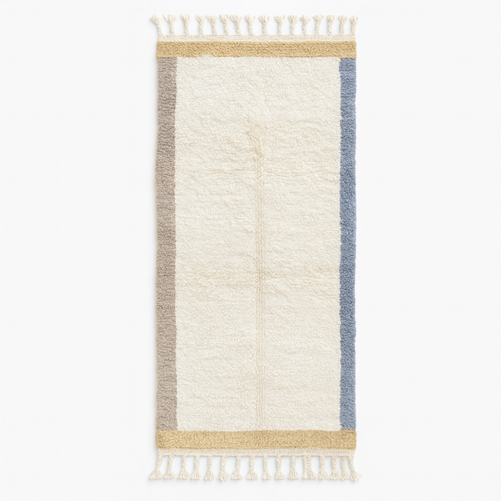 Handmade Moroccan runner rug with white wool center, blue borders, and beige accents, crafted by Berber artisans.