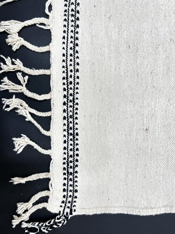 Handmade Moroccan runner rug with abstract  purple and black geometric shapes on white background, minimalist flatwoven wool hallway rug