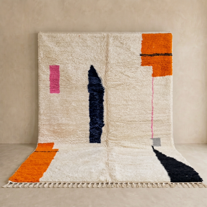 Minimalist Moroccan wool rug with abstract navy, orange and pink line design on cream background
