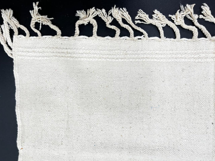 Handwoven Moroccan flatweave wool rug with mint green and black geometric design on ivory background