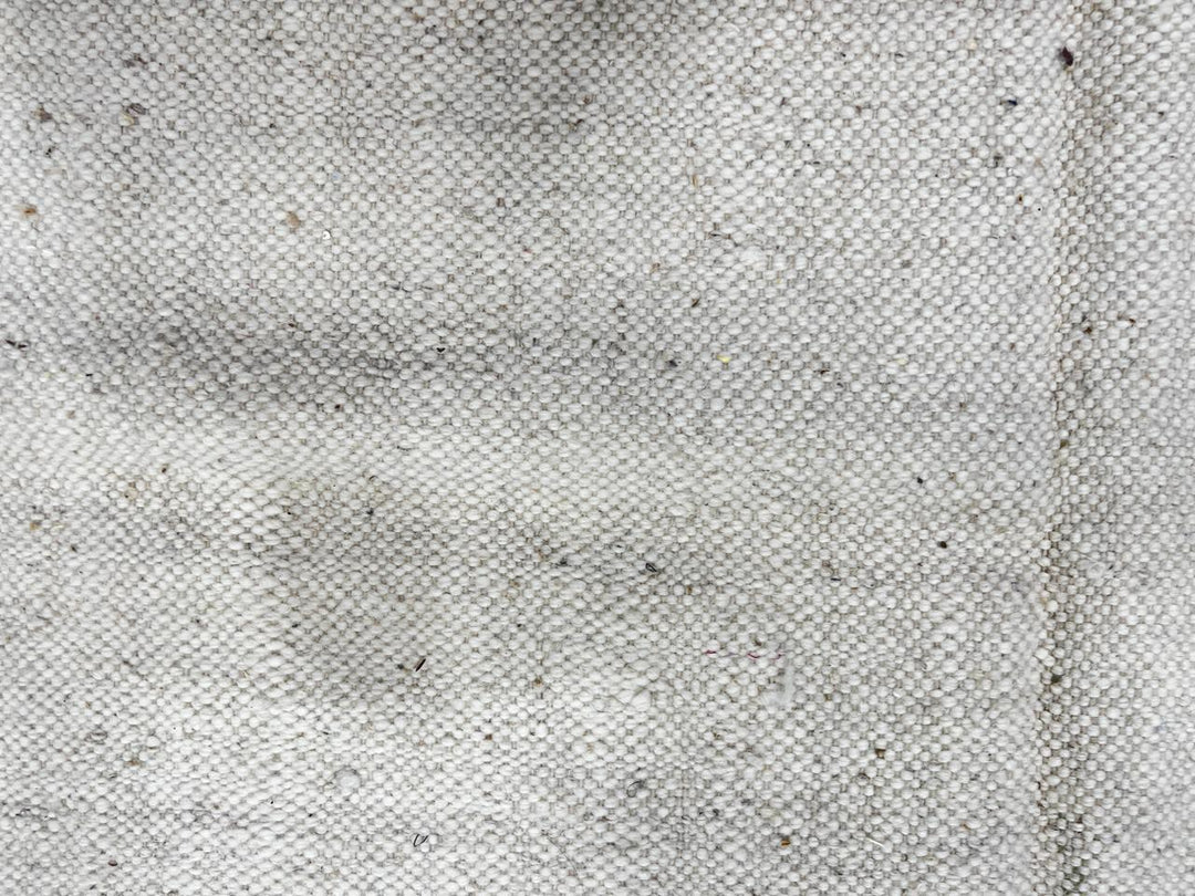 Handwoven Moroccan flatweave wool rug with mint green and black geometric design on ivory background