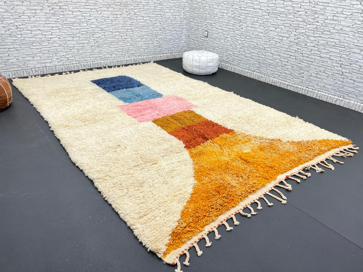 Handmade Moroccan wool rug with modern abstract geometric design in navy, teal, pink, orange, and mustard tones