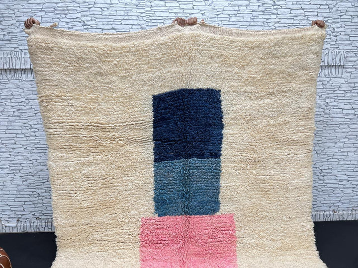 Handmade Moroccan wool rug with modern abstract geometric design in navy, teal, pink, orange, and mustard tones