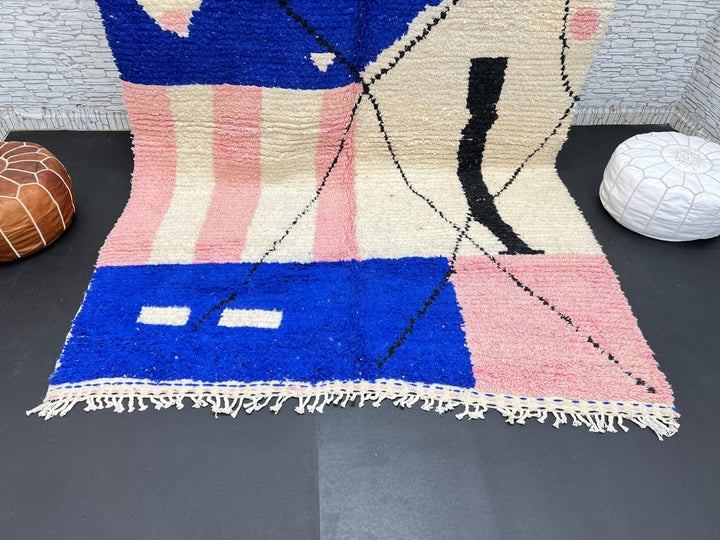 Handmade modern Moroccan wool rug with blue, pink, ivory, and black geometric abstract design