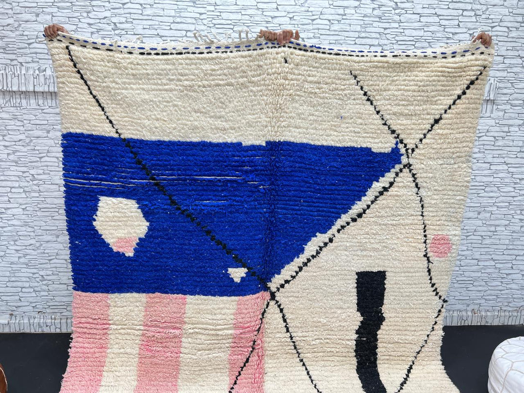 Handmade modern Moroccan wool rug with blue, pink, ivory, and black geometric abstract design