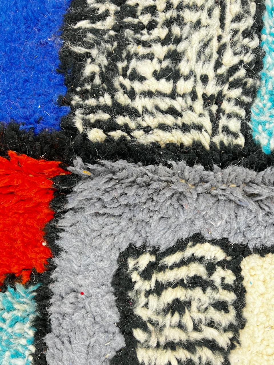 Colorful abstract Moroccan runner rug with artistic face design, handmade wool carpet featuring turquoise, yellow, red and purple shapes on a soft white background, modern boho Moroccan wool runner for hallway decor.