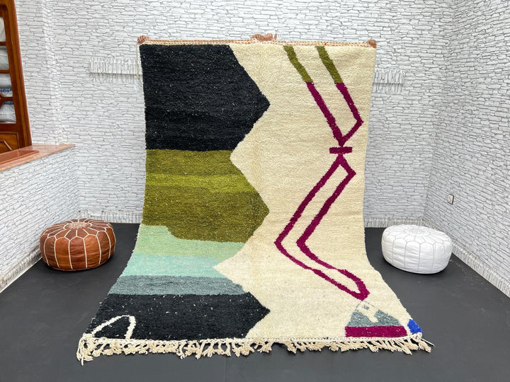 Handwoven Moroccan wool rug with abstract modern design in green, black, and magenta