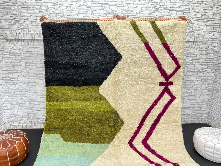 Handwoven Moroccan wool rug with abstract modern design in green, black, and magenta