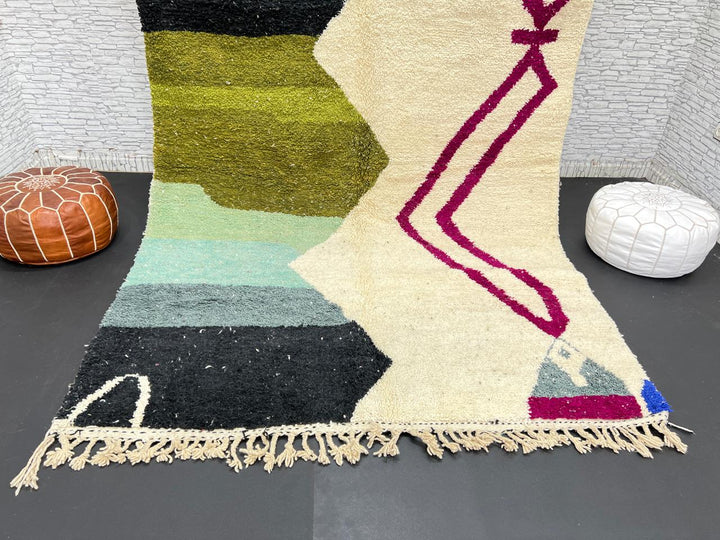 Handwoven Moroccan wool rug with abstract modern design in green, black, and magenta