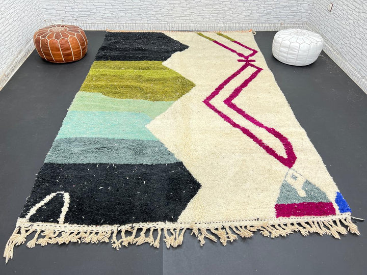 Handwoven Moroccan wool rug with abstract modern design in green, black, and magenta