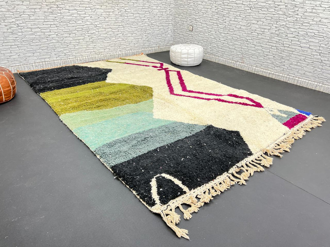 Handwoven Moroccan wool rug with abstract modern design in green, black, and magenta