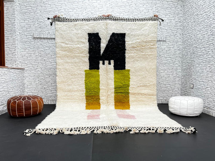 Modern abstract Moroccan wool rug with geometric blocks in black, green, and ochre, handmade by Berber artisans
